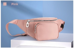 Detailed view of pink water-resistant waist bag with metal zippers and adjustable strap