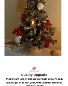 Mini cedar desktop Christmas tree with warm lights and red velvet bow on wooden base