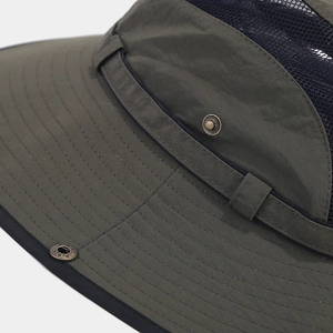 Detail of dark green outdoor bucket hat featuring breathable mesh and reinforced brim