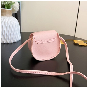 Detailed view of pink mini PU leather saddle bag with neat stitching for girls