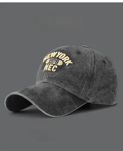 Close-up of yellow 3D embroidery on washed cotton charcoal grey baseball cap