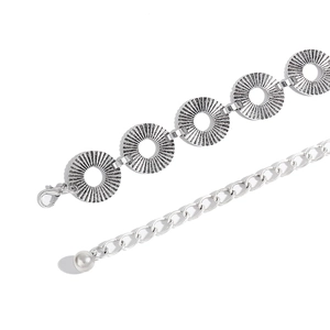 Detail of silver punk waist chain with sunburst textured rings and lobster clasp