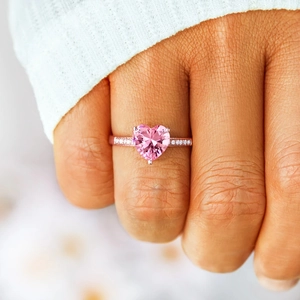 S925 silver heart ring with pink zircon on woman's hand, rose gold finish luxury design