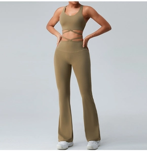 Detail view of the back-crossed straps on olive green yoga bra and flared fitness pants