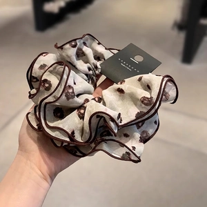 Elegant floral chiffon scrunchie with layered ruffles and brown animal print design