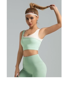 Detail of high-stretch sports bra with color-block design and U-shaped back for fitness