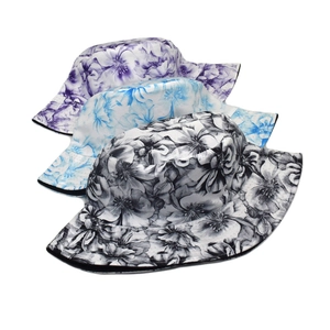 Detailed close-up of floral print bucket hats in purple, blue, and black cotton canvas