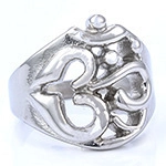 Macro view of silver hollow Om symbol design on a trendy spiritual metal ring