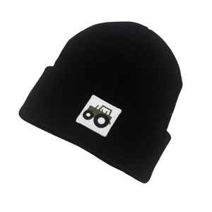 Close-up of the ribbed knit fabric and green tractor embroidery on the black baby beanie