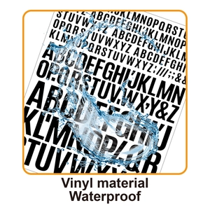 Macro shot of black vinyl waterproof alphabet stickers with splashing water effect