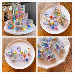 Detail of colorful matte star and heart hair clips in a transparent gift box packaging