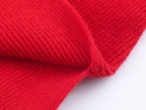 Dettaglio macro della maglia a coste rossa del maglione con trama in lana morbida
