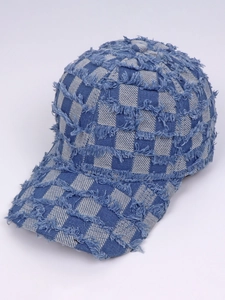 Detail view of denim plaid baseball cap with distressed frayed edges and check pattern