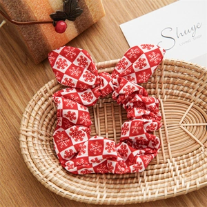 Detail of red and white checkered scrunchie with snowflakes and rabbit ear bow decoration