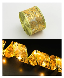 Detail of gold LED Christmas ribbon showing warm star patterns and spiral lighting effects