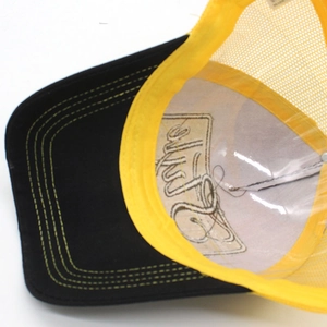 Detail view of the black and yellow mesh cap interior showing embroidery and stitching