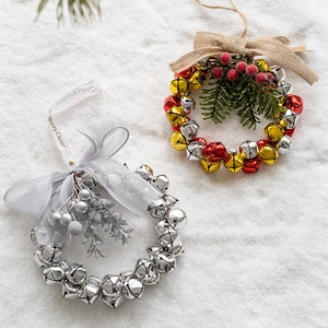 Christmas bell wreath ornaments with red gold silver bells and festive green leaves