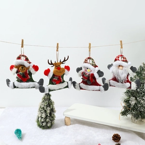 Detail of plush Christmas ornaments with bear, deer, snowman and Santa on a white background