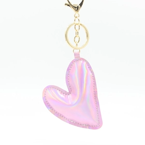 Pink iridescent heart-shaped PU leather keychain with gold metal clasp on white background