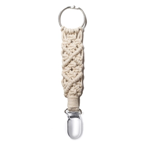 Macro detail of hand-woven beige macrame hat clip with metal ring and duckbill clasp