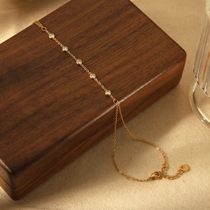 Elegant 18k gold plated stainless steel bracelet with round zircon stones on wood box