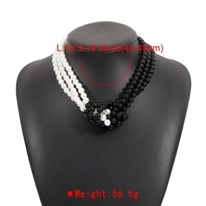 Detail of multi-layered black and white pearl necklace with knotted design and size specs