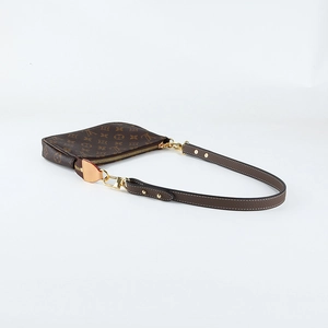 Close-up of brown monogram leather shoulder strap with litchi grain and metal buckle