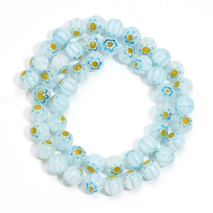 Macro shot of light blue millefiori glass beads with floral patterns for jewelry making
