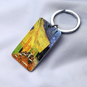 Macro view of rectangular steel keychain with Van Gogh Café Terrace at Night oil painting