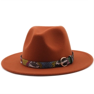 Detail of caramel fedora hat featuring a colorful python skin band and gold buckle