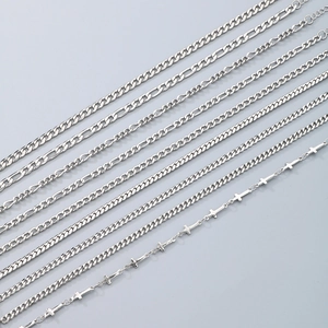 Detailed view of assorted silver titanium steel NK and Figaro anklet chain styles
