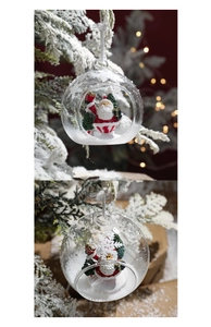 Macro detail of clear Christmas glass ball with Santa Claus figurine and fake snow