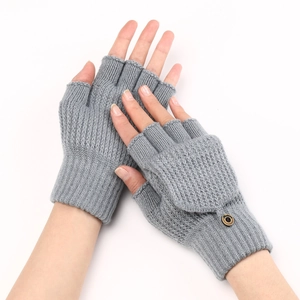 Detail view of grey knitted fingerless gloves showing thick texture and button design