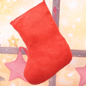 Detailed view of red sequin Christmas stocking made of felt for holiday gift packaging