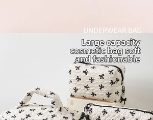 Detailed set of three quilted bow cosmetic bags with zippers and elegant bow charms