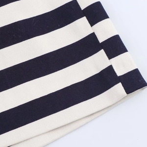 Macro detail of navy and white striped high-waisted shorts showing twill cotton texture