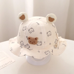 Detail of baby sun hat featuring cute 3D bear ears and cartoon bear patterns