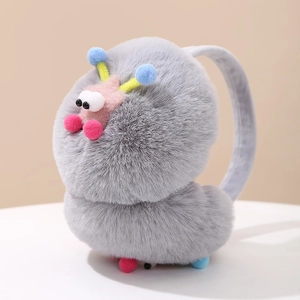 Close-up of grey plush earmuffs showing soft texture and colorful pompom star details