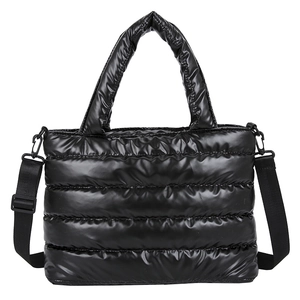 Quilted black puffer bag with glossy nylon finish and detachable shoulder strap