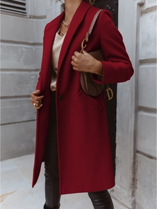 Detailed view of dark red wool coat featuring a wide lapel and single button closure