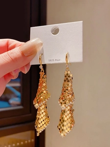 Close-up of 18k gold-plated tassel earrings with S925 silver needles on white card
