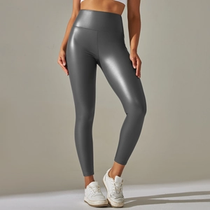 Macro detail of high-waist faux leather leggings with metallic finish and wide waistband
