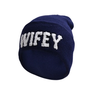 Close-up of WIFEY white embroidery texture on navy blue knitted winter beanie hat