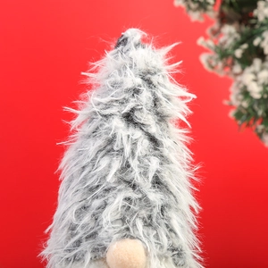 Macro detail of Christmas gnome plush doll featuring long grey faux fur and soft knit fabric
