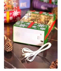 Detail view of the Christmas music box base showing battery compartment and USB port