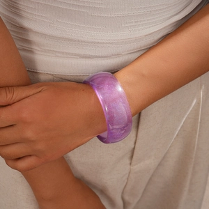 Macro view of wide translucent purple resin bangle with fine silver glitter detail