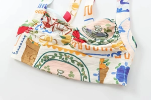 Detail of colorful bohemian print and pleated chest design on a cropped tube top