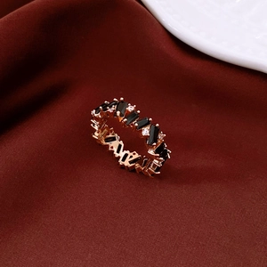 Detail view of vintage rose gold ring with black baguette zircon and white crystals