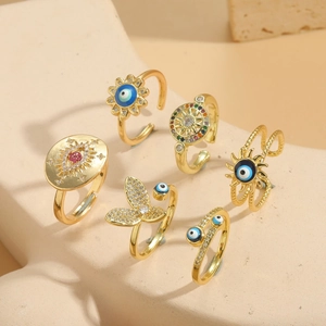 Macro detail of adjustable evil eye rings with sunflower and butterfly motifs
