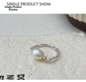 Macro shot of S925 silver ring featuring a white pearl and textured crushed silver band